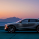A profile photo of a Cadillac Lyriq with mountains and a sunset in the background.